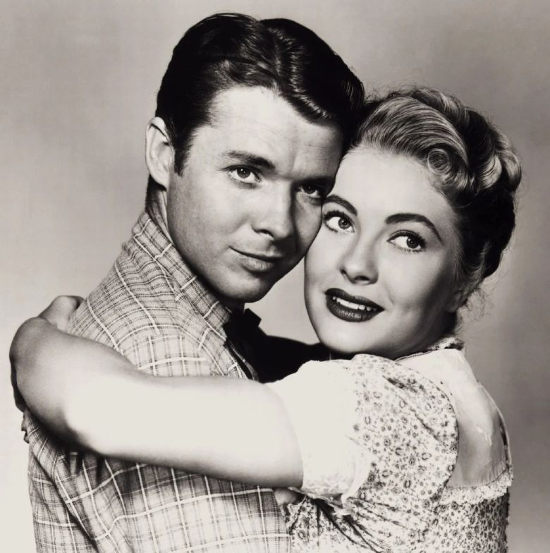 black and white photo of audie murphy and lori nelson holding each other