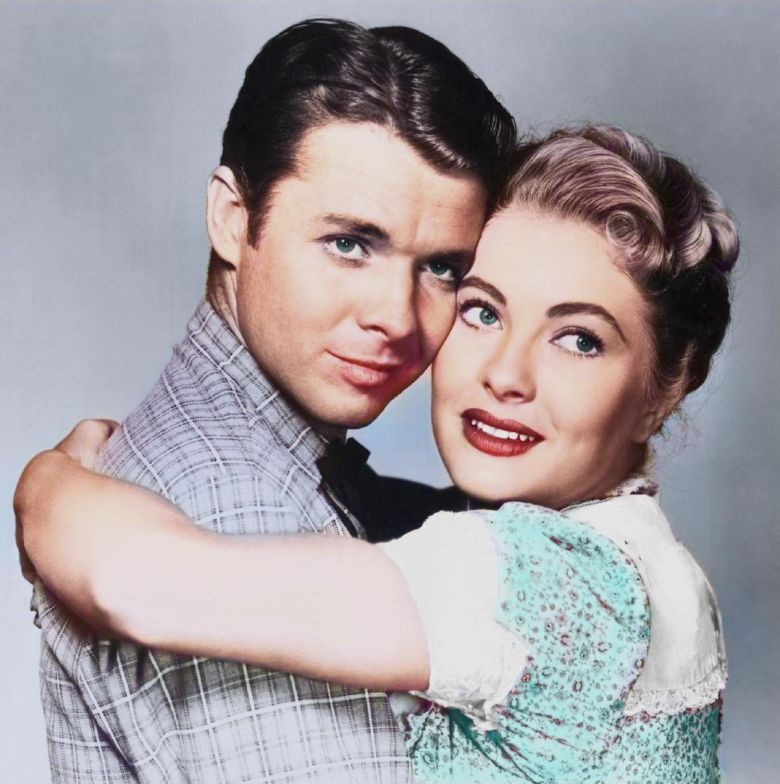 colorized picture of audie murphy and lori nelson posing for a camera